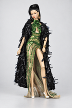 Fashion doll wearing an emerald high-slit gown framed by a long black coat with glossy projecting embellishments.
