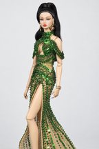 Close view of the green beaded high neckline, teardrop keyhole, nude-toned mesh and draped upper-arm strands.