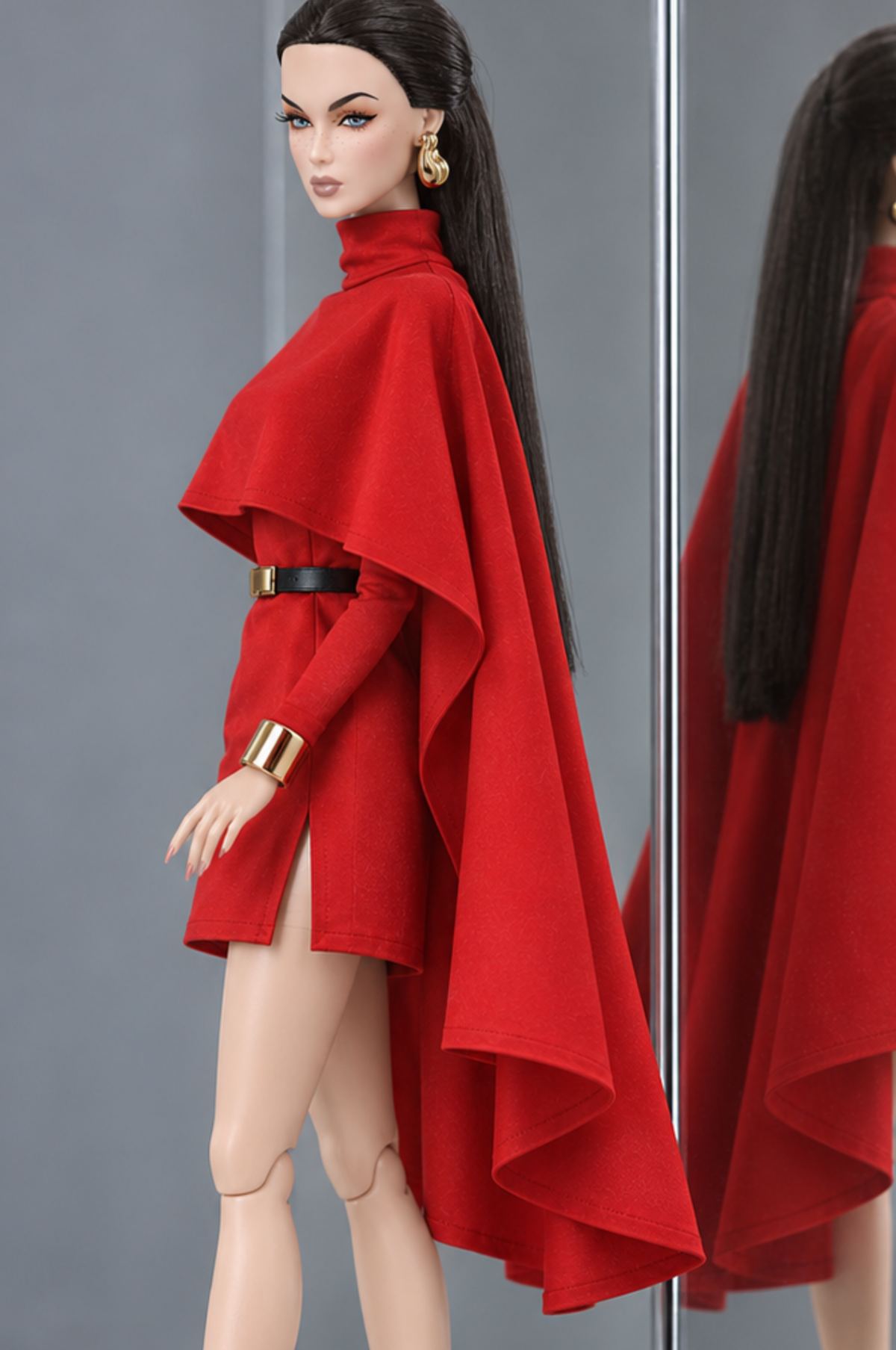 Side view of the red LE SALON cape mini dress, with the cape extending below the mini hem along the back.