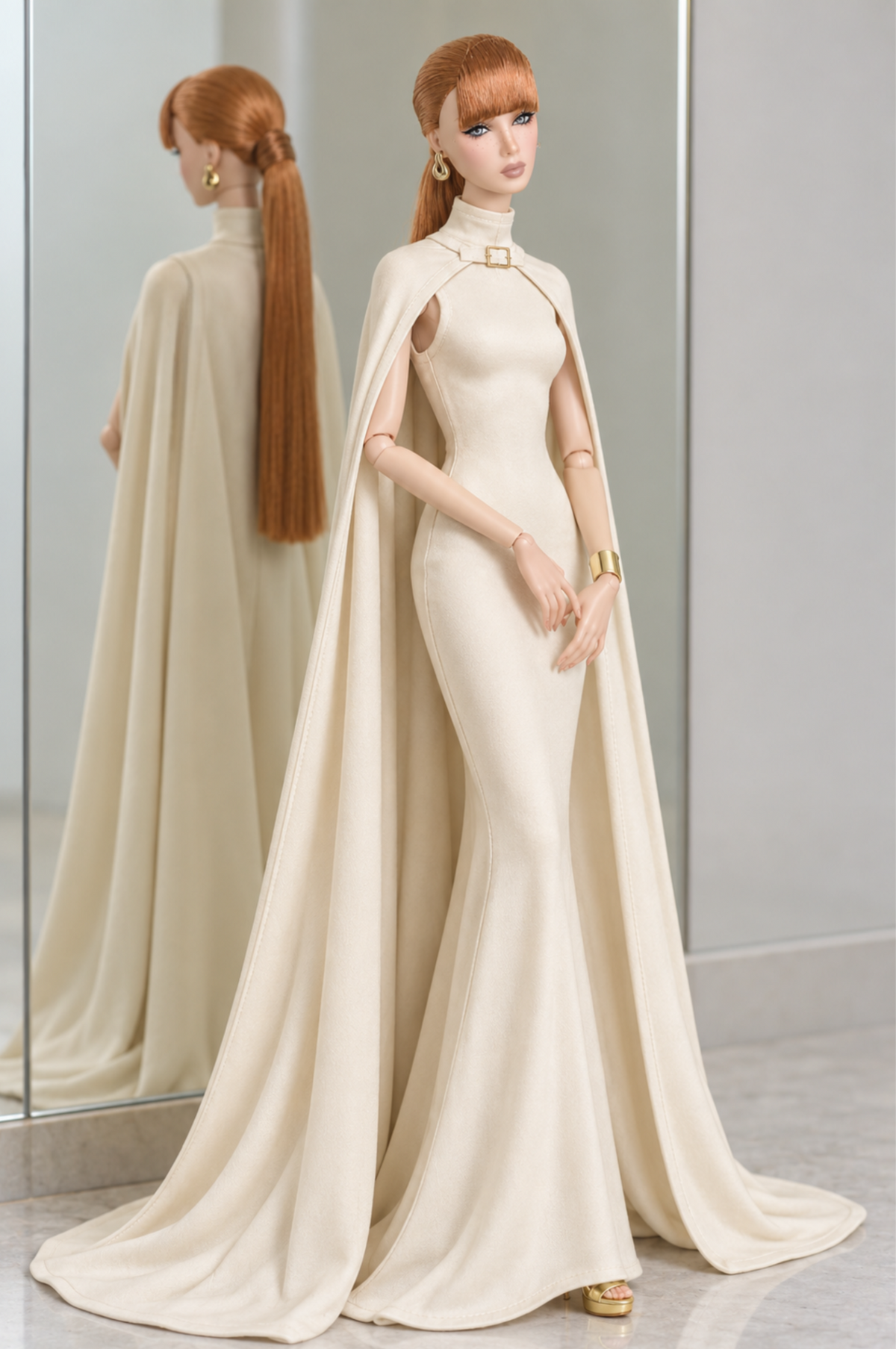 Full-length front view of LE SALON No. 02 ivory cape gown, with a fitted silhouette and long cape panels resting on the floor.