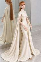 Three-quarter view of the ivory LE SALON cape gown, showing its high collar, open shoulder area and softly flared hem.