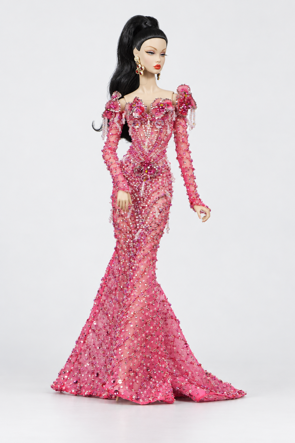 Three-quarter full-length view of the pink floral embellished doll gown, fitted hips and sweeping train.