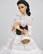 Close-up of lace collar, sheer sleeves, brown corset and wicker basket