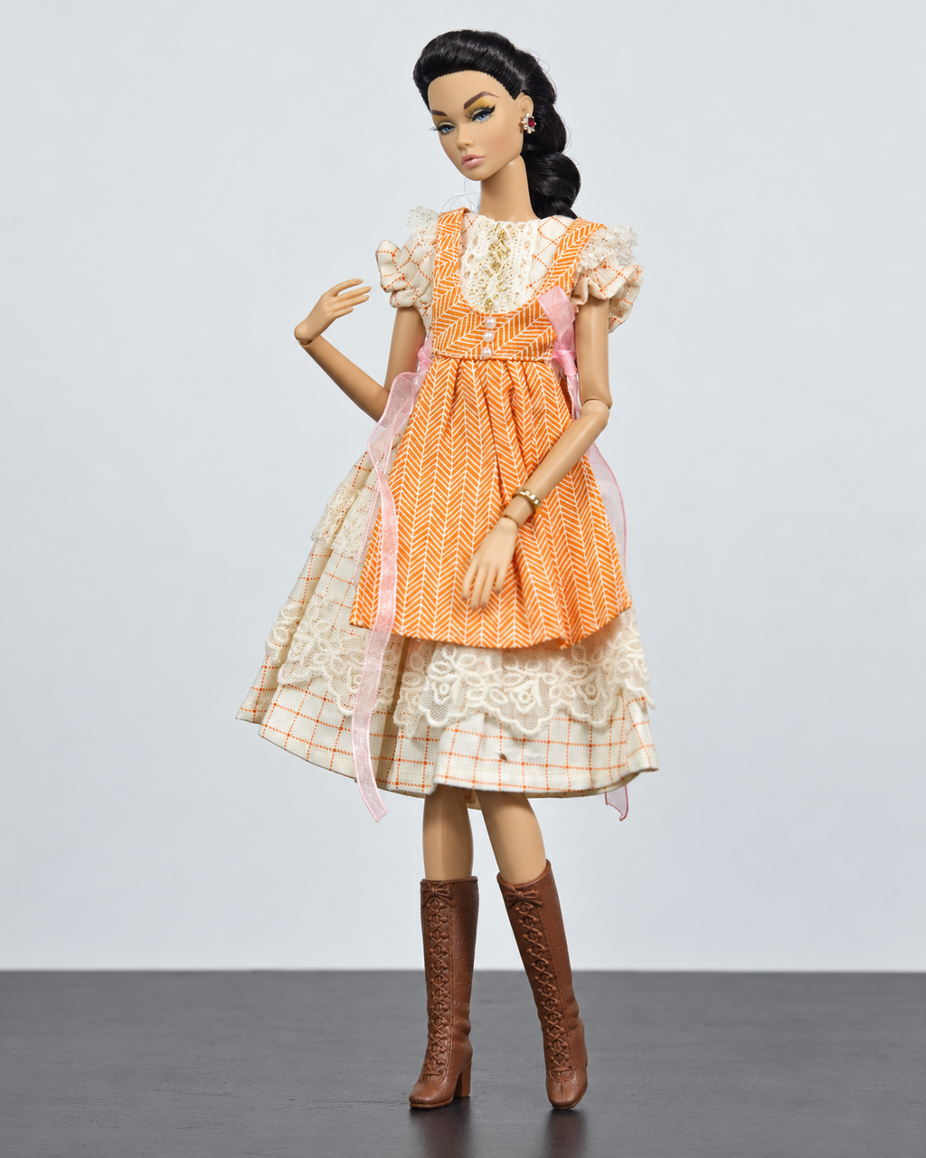 Set A orange pinafore with pink ribbons over checked lace dress