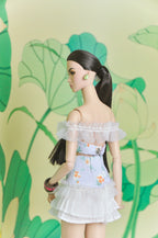 Back view of the Spring Aura floral two-piece doll outfit with off-shoulder ruffles