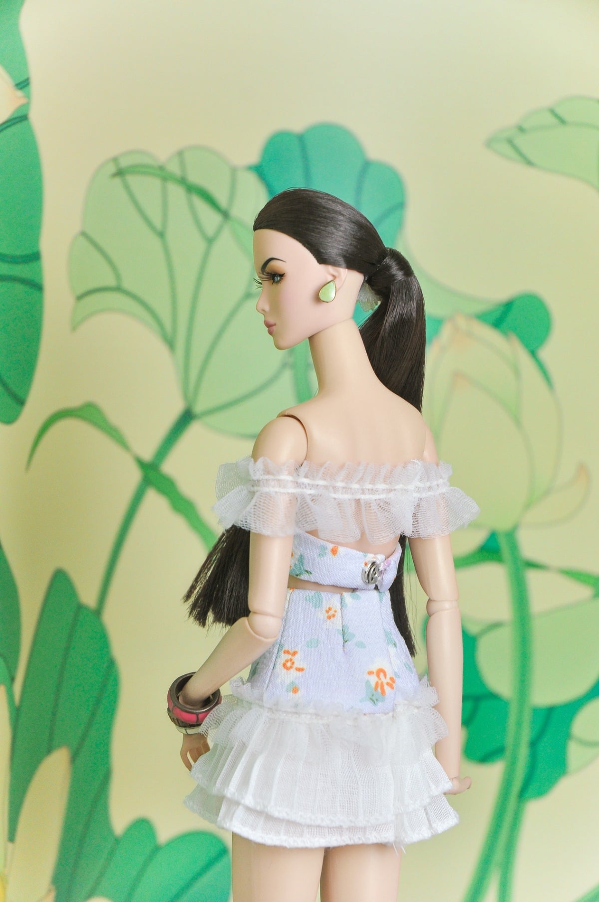 Back view of the Spring Aura floral two-piece doll outfit with off-shoulder ruffles