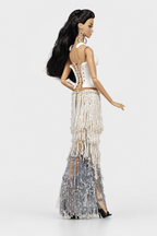 Rear three-quarter view showing the white bodice's crisscross back lacing and cascading ivory and silver bead strands.